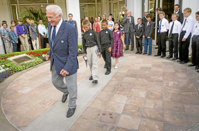 Apollo 11 astronaut Buzz Aldrin leads area school children through moon walk footprints