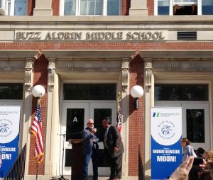 Apollo 11 moonwalker Buzz Aldrin and Ron Bolandi, Superintendent of the Montclair School Sys-tem, chat together under the new sign for the renamed Buzz Aldrin Middle School. Credit: Buzz Aldrin Middle School